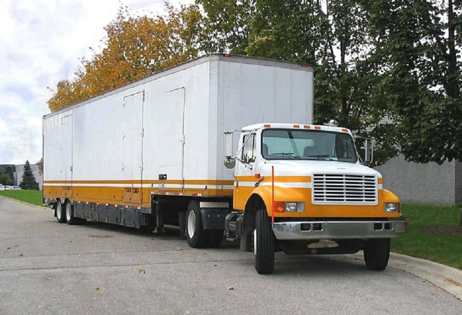 this is a picture of a moving van at an office building ready to pick up furniture.